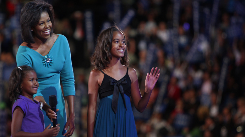 Sasha Obama, Michelle Obama, and Malia Obama on stage