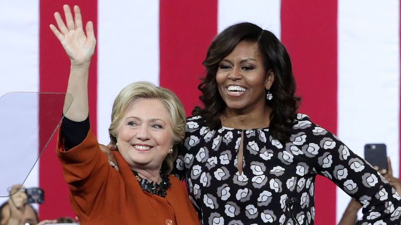 Hillary Clinton and Michelle Obama waving