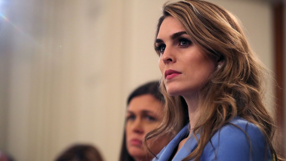 Hope Hicks profile, wearing a light blue blazer, with a serious expression