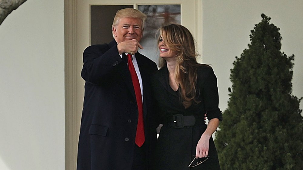 Donald Trump pointing at Hope Hicks as she laughs