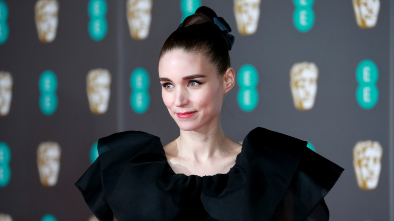 Rooney Mara smiling with chin tilted downward