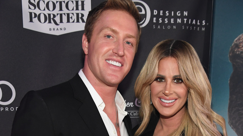 Kim Zolciak and Kroy Biermann smiling on the red carpet