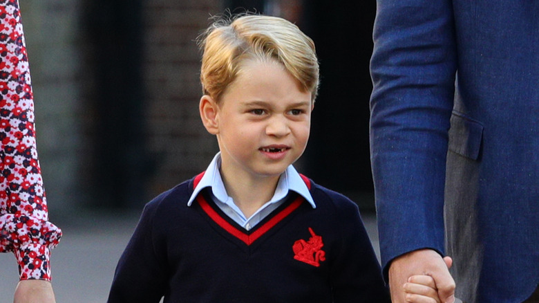 Prince George of Wales holding Prince William's hand