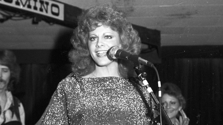 Young Reba McEntire performing on stage.