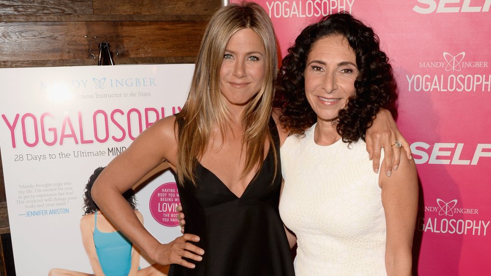 Jennifer Aniston and Yogalosophy inventor Mandy Ingber, smiling and posing arm in arm