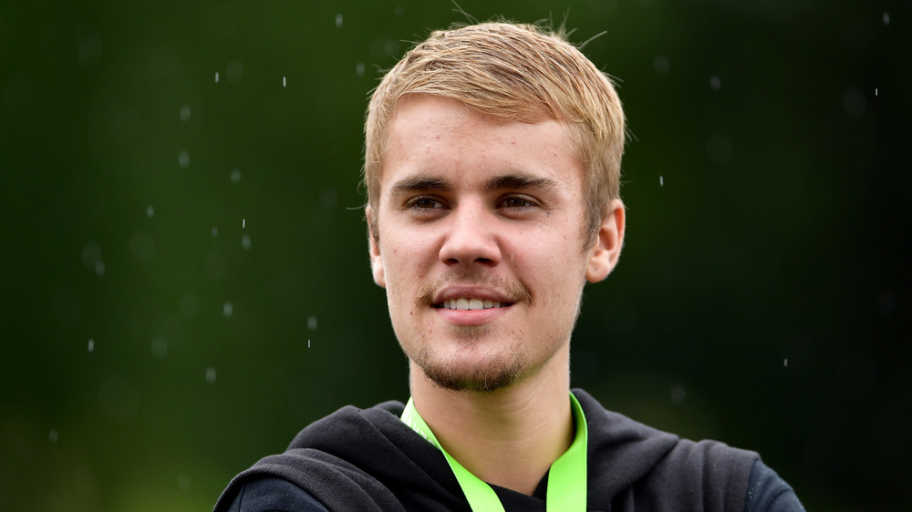 Justin Bieber standing in the rain