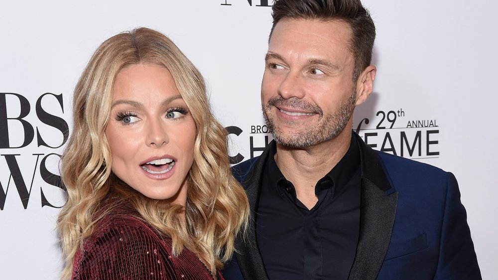 Kelly Ripa and Ryan Seacrest getting cheeky in 2019