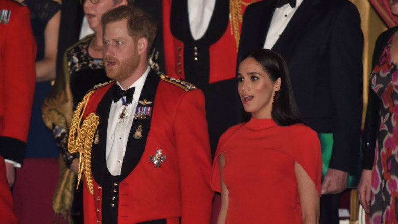 Prince Harry and Meghan Markle standing with mouths open