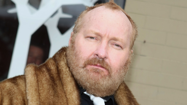 Randy Quaid staring at camera and frowning