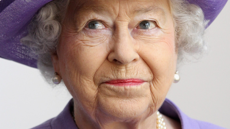 Queen Elizabeth wearing purple hat