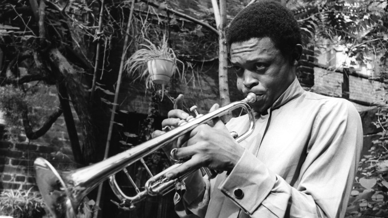 Hugh Masekela playing trumpet