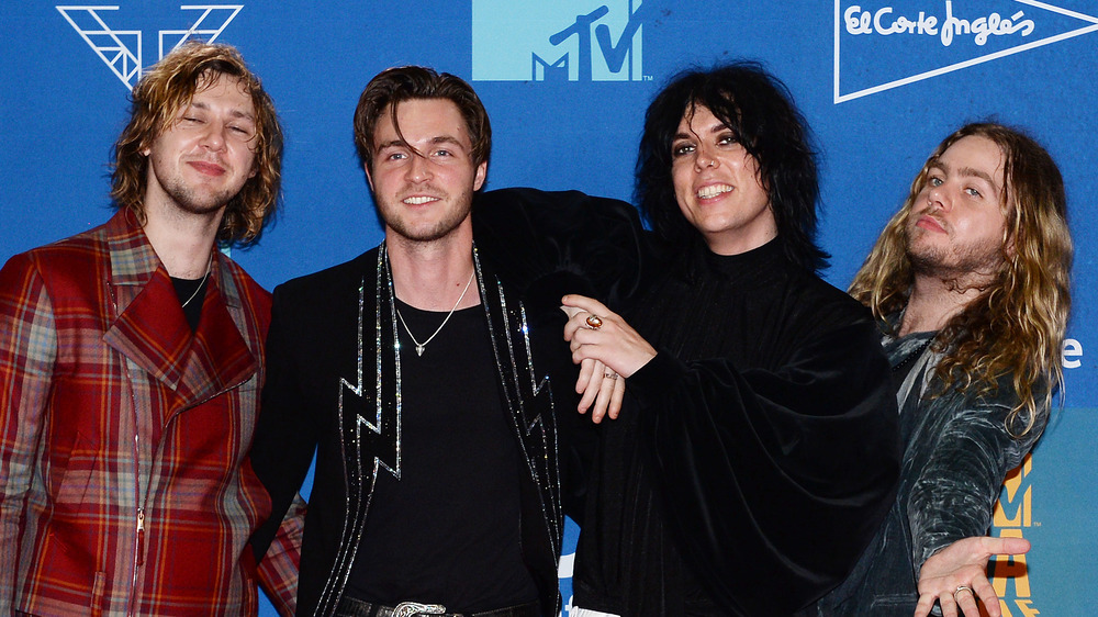 The Struts posing on a red carpet