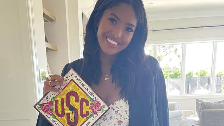 Natalia Bryant smiles in her graduation gown