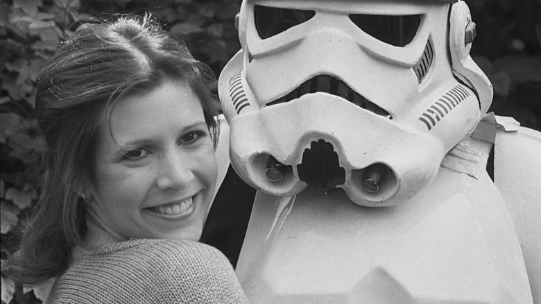 Carrie Fisher smiling with a Stormtrooper