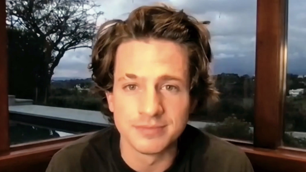 Charlie Puth, video call, shaven, long hair, looking sad