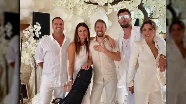 Friends of Chris Hemsworth and Elsa Pataky (far right respectively) posing together and smiling in all-white outfits