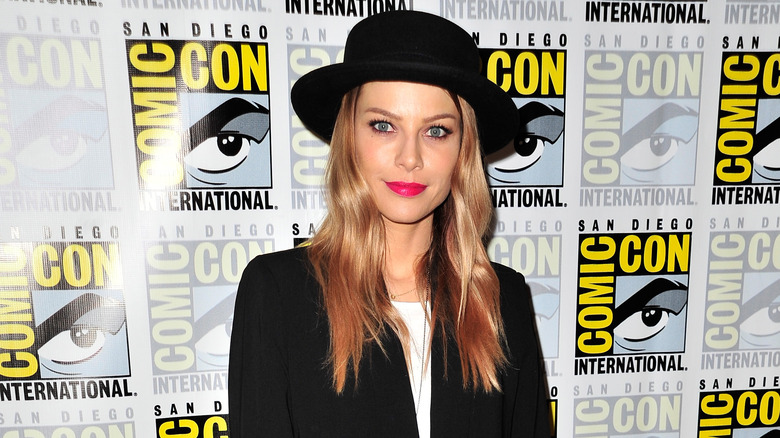 Lauren German smirks in black hat