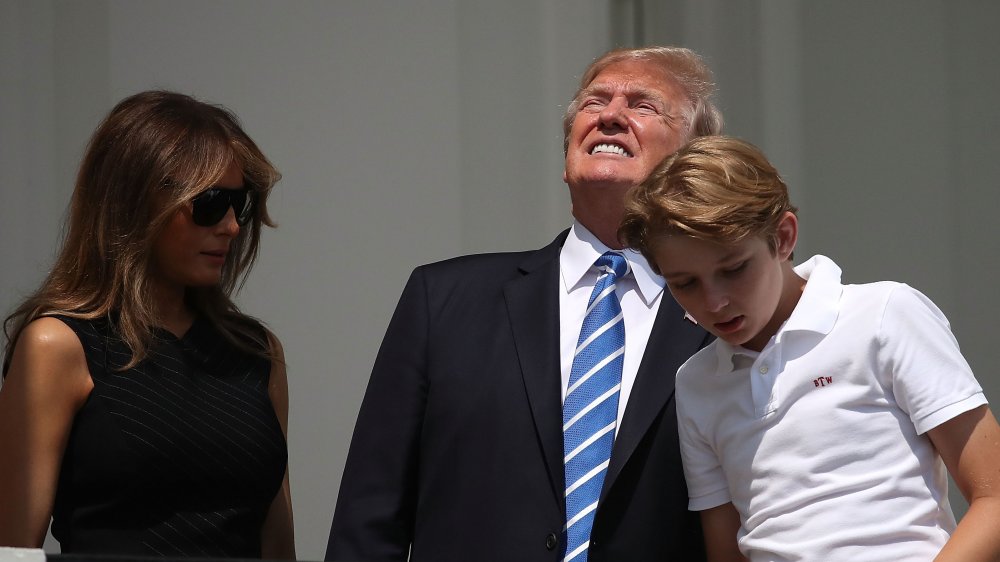 Trump looking directly into solar eclipse with Melania and Barron 