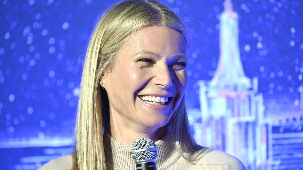 Gwyneth Paltrow laughing with a microphone