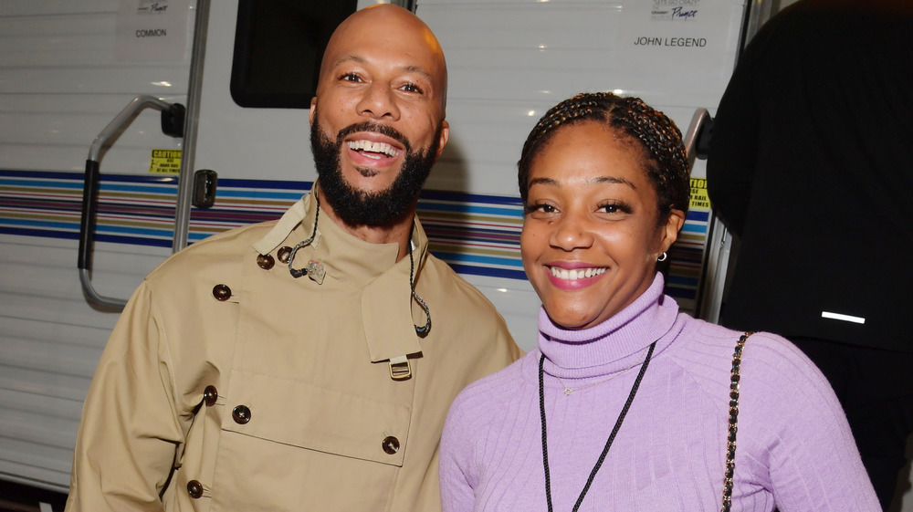 Tiffany Haddish and Common smiling 