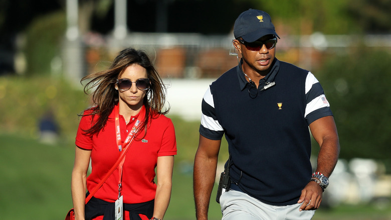 Erica Herman and Tiger Woods on the golf green