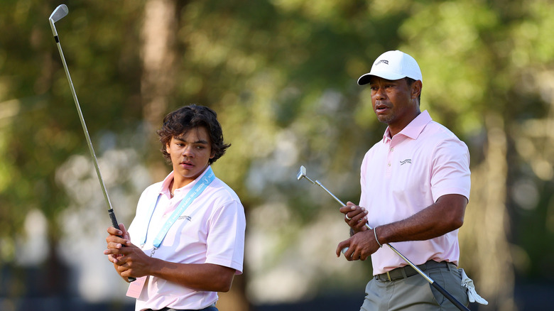 Charlie and Tiger Woods playing golf together.