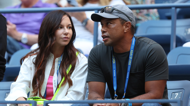 Erica Herman and Tiger Woods sit at the US Open