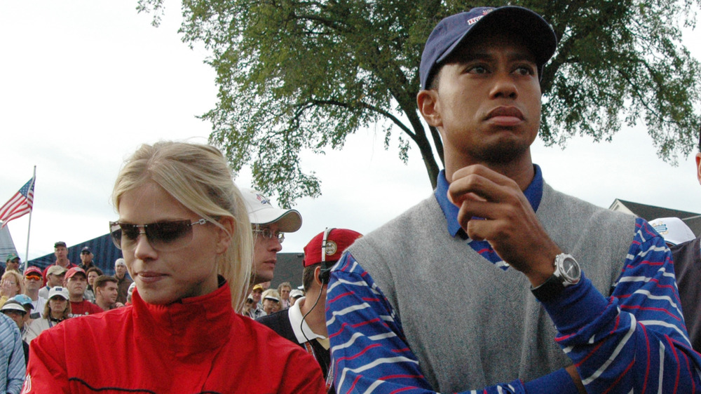 Elin Nordegren and Tiger Woods stand together 