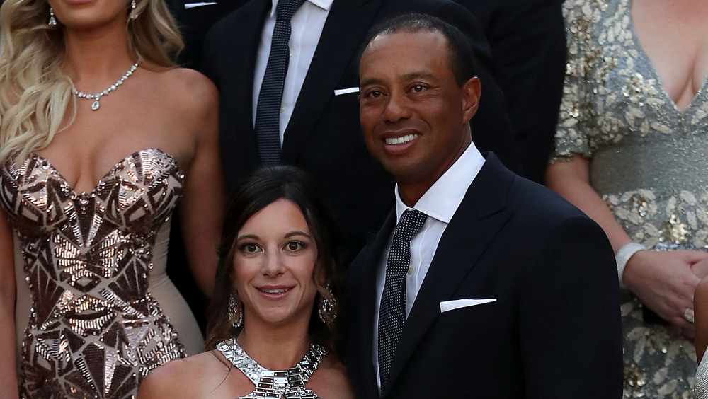 Tiger Woods and Erica Herman smiling at an event