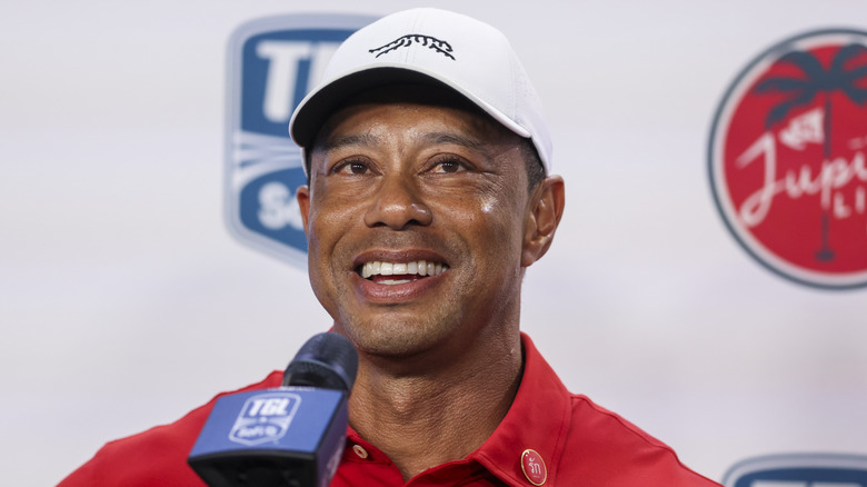 Tiger Woods speaking into a microphone