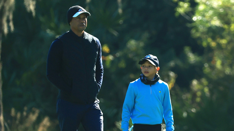 Tiger Woods and Charlie Woods walking