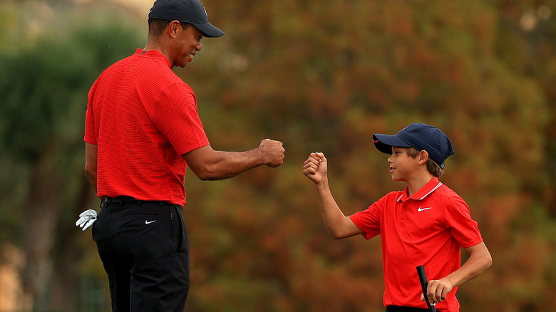 Tiger Woods and Charlie Woods do a fist bump