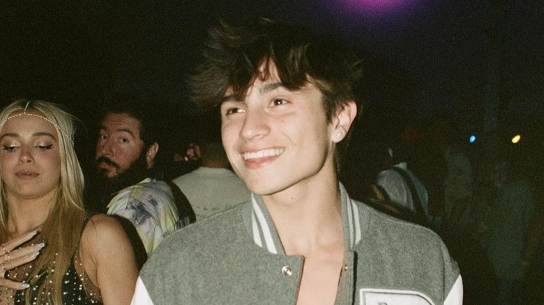 Cooper Noriega smiling at a party whil wearing a letter jacket