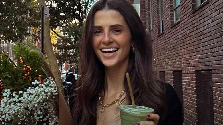 Rachel Yaffe smiling while holding a green drink