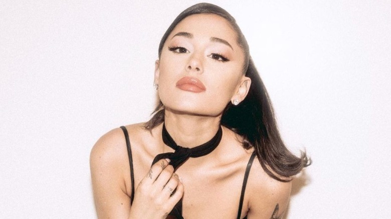 Ariana Grande wearing black neck scarf