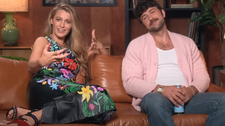 Blake Lively sitting on couch with  Brandon Sklenar