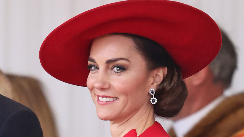 Kate Middleton smiling in red