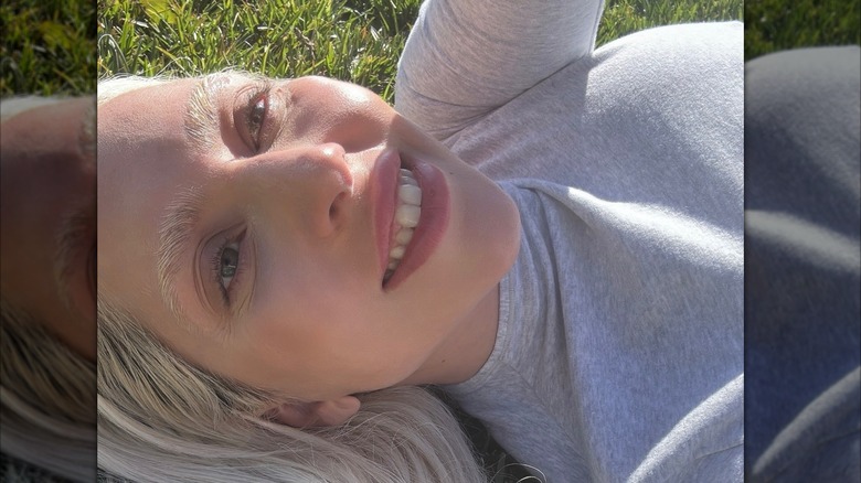 Lady Gaga lying on a grass