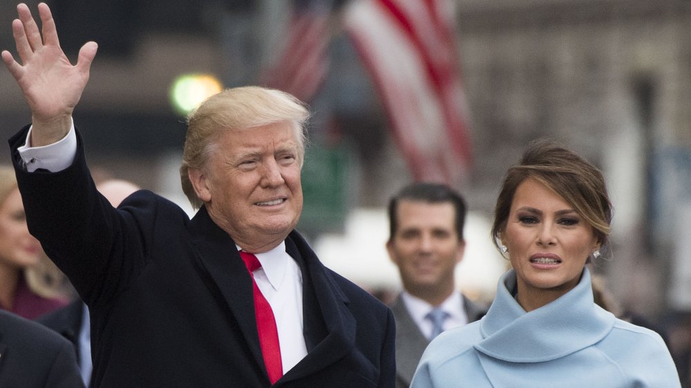 Donald Trump waving and Melania Trump next to him