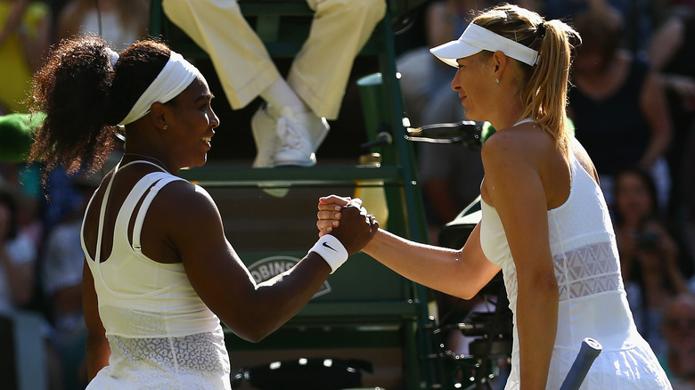 Serena Williams and Maria Sharapova hold hands in 2015