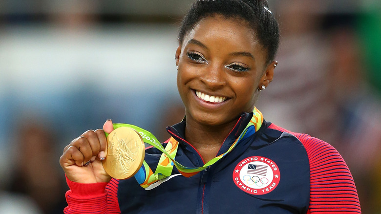 Simone Biles holding medal