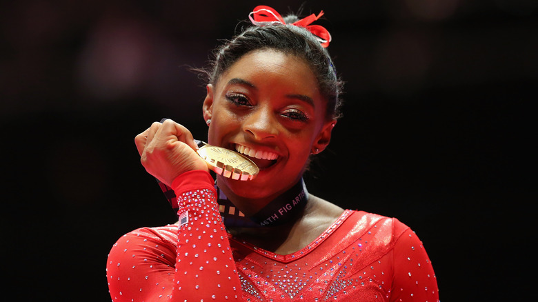 Simone Biles biting medal