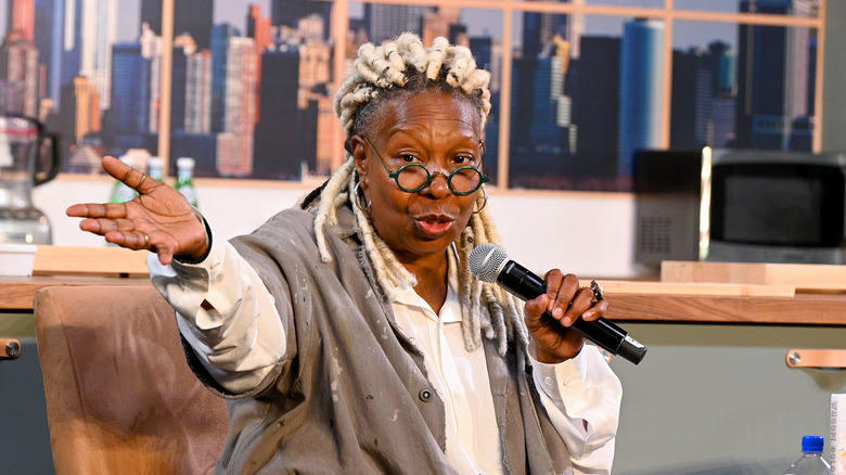 Whoopi Goldberg holding a microphone