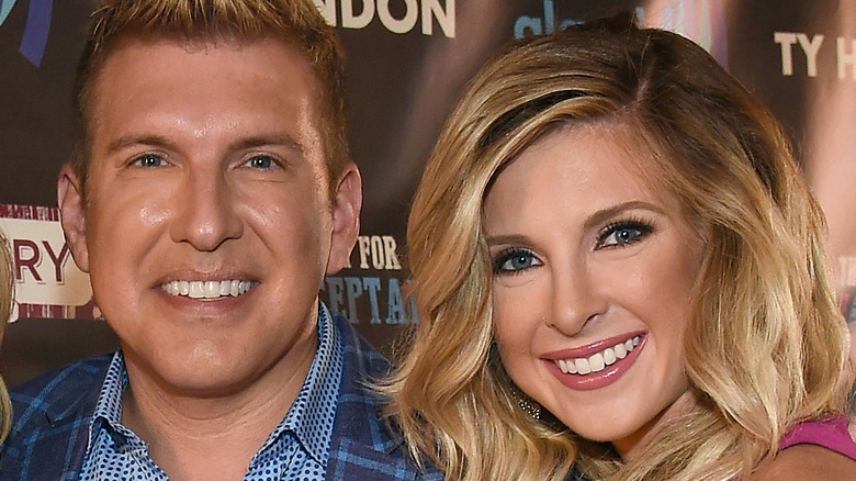 Todd Chrisley and Lindsie Chrisley, both smiling