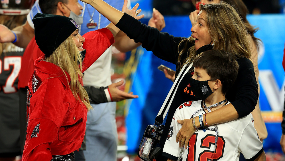 Camille Kostek and Gisele Bundchen getting ready to hug