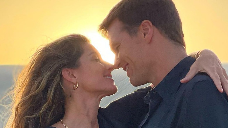 Gisele Bundchen and Tom Brady in front of a sunset