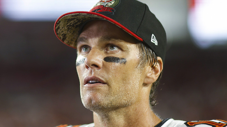 Tom Brady in cap and wearing eye black