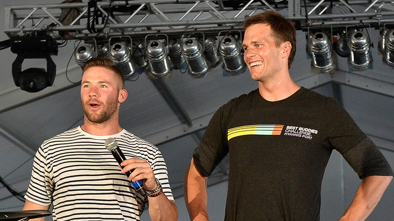 Julian Edelman and Tom Brady on stage