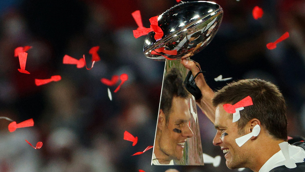 Tom Brady holding the Super Bowl LV trophy