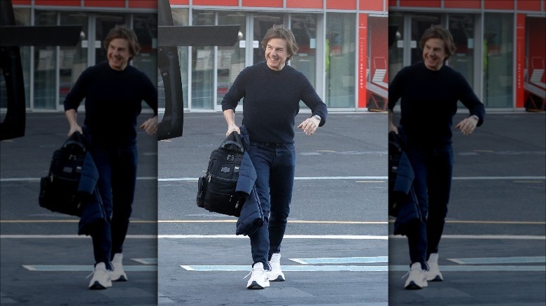 Tom Cruise smiles while walking